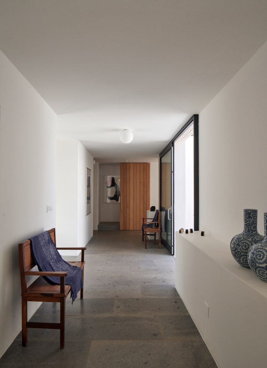 White walkway with chairs and stone floor