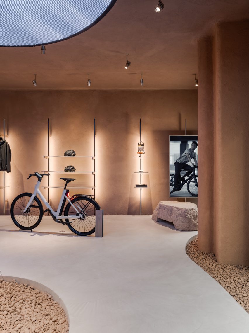 Organically shaped bike shop interior with curved earth rendered walls