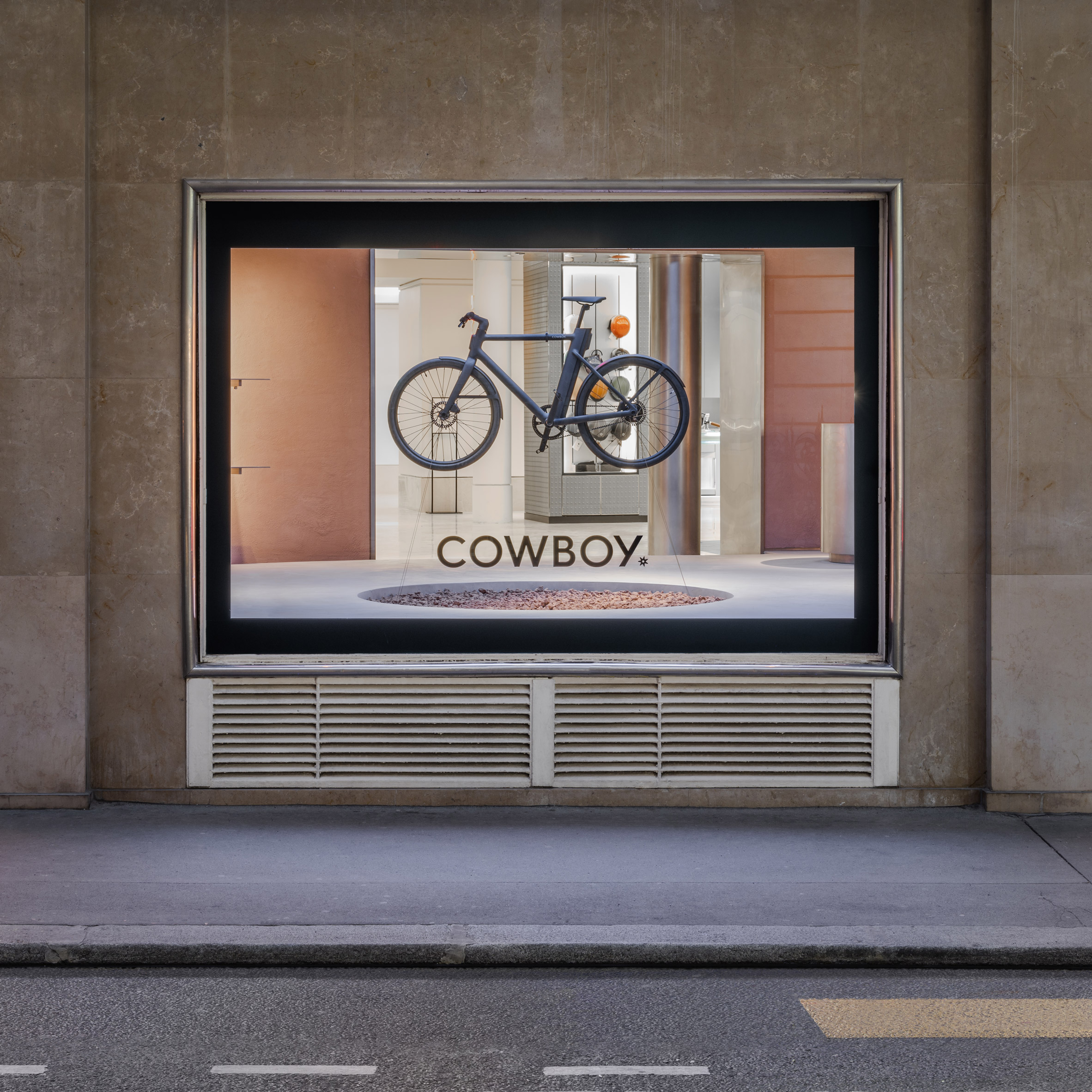 Exterior shop of bike hanging in window of Cowboy e-bike shop in Paris by Ciguë