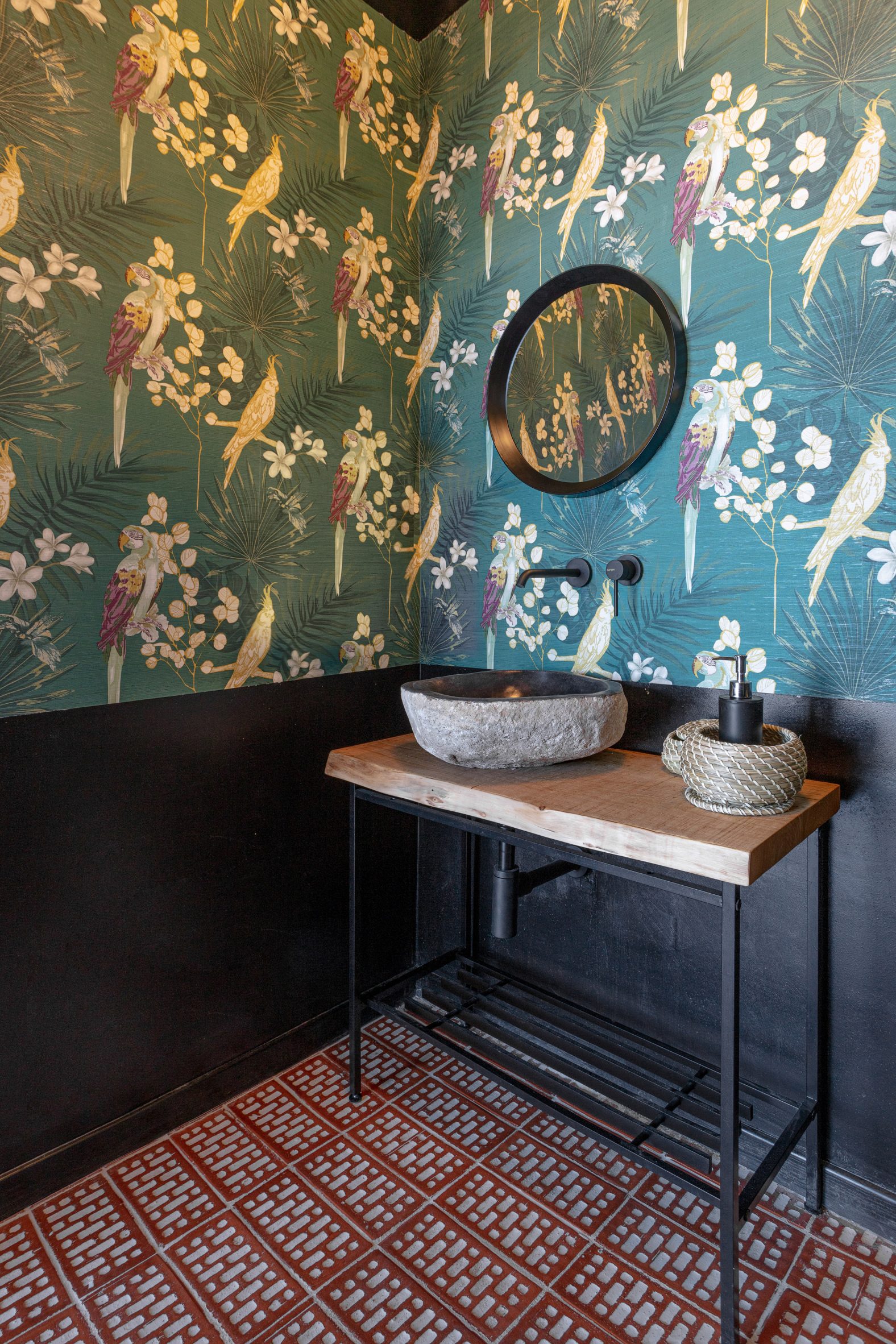 Green wallpaper with exotic patterns in bathroom of cocktail by Gae Avitabile