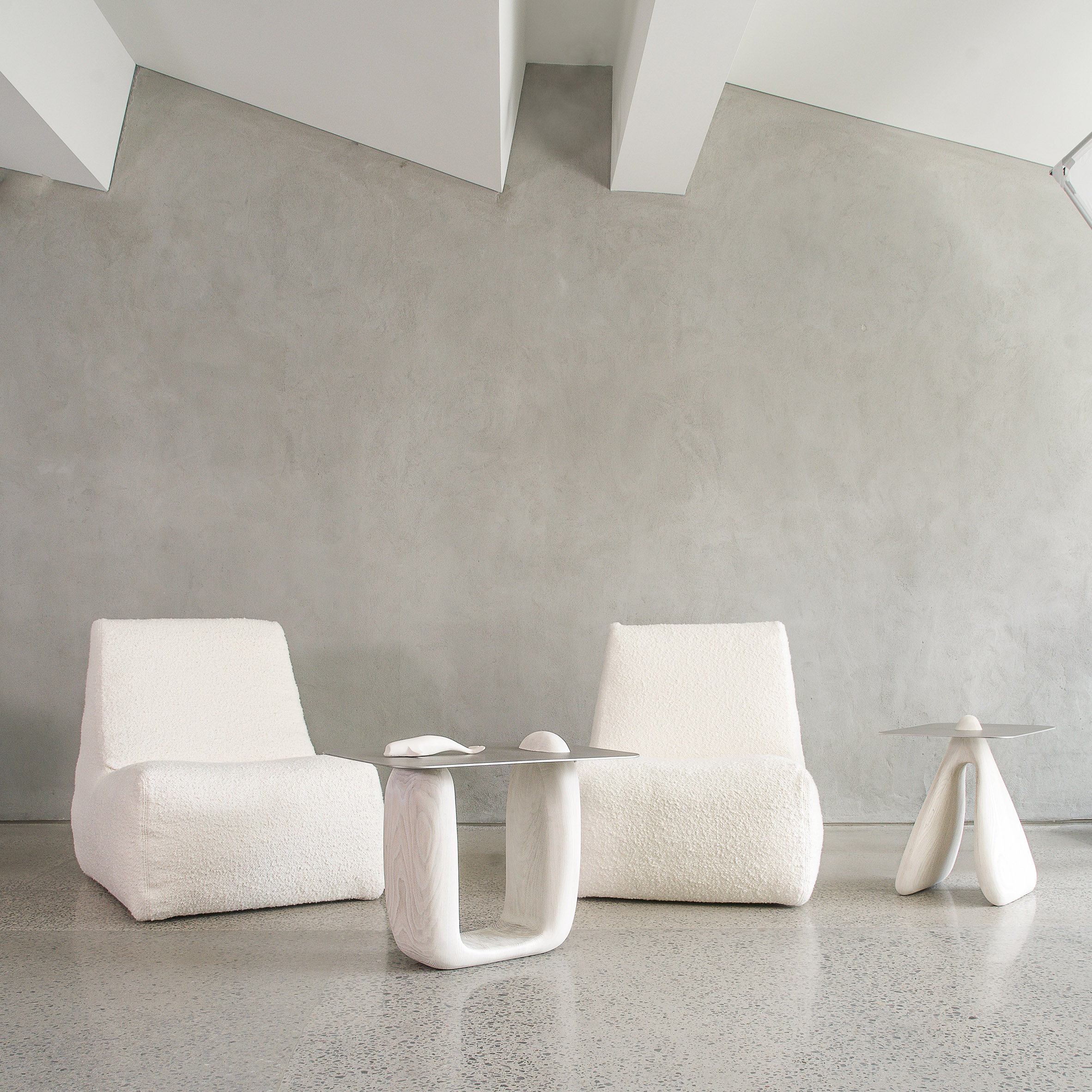 Two Coralis tables by Nadine Hajjar Studio next to two white seats
