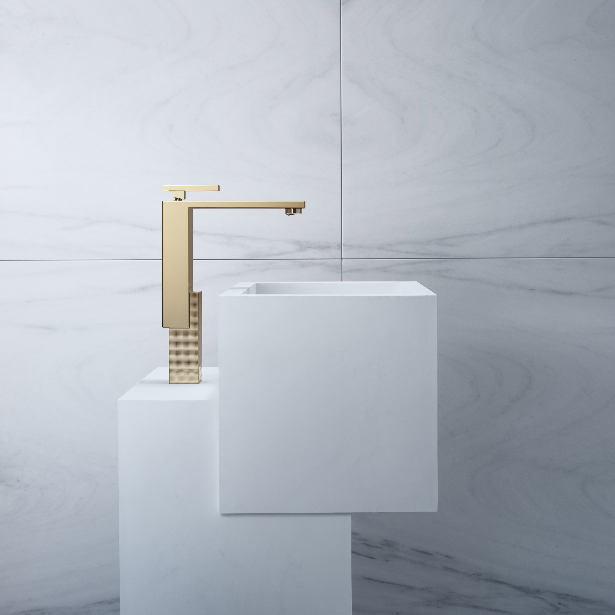 Gold tap on a sculptural white sink