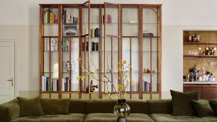 Living room of Home Dijkhuis by Studio Modijefsky with green sofa large timber bookcase