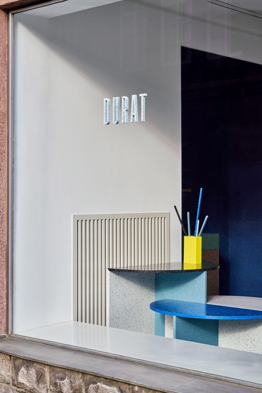 Window display of blue- and grey-toned coffee and side tables made of Durat material in the Helsinki showroom