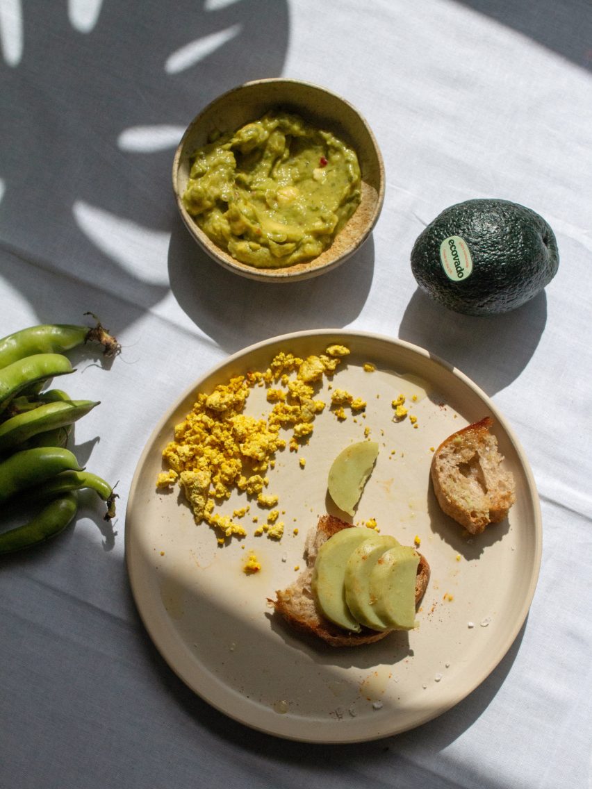 Photo of Ecovado sliced on toast on a plate surrounded by green dip and broad beans