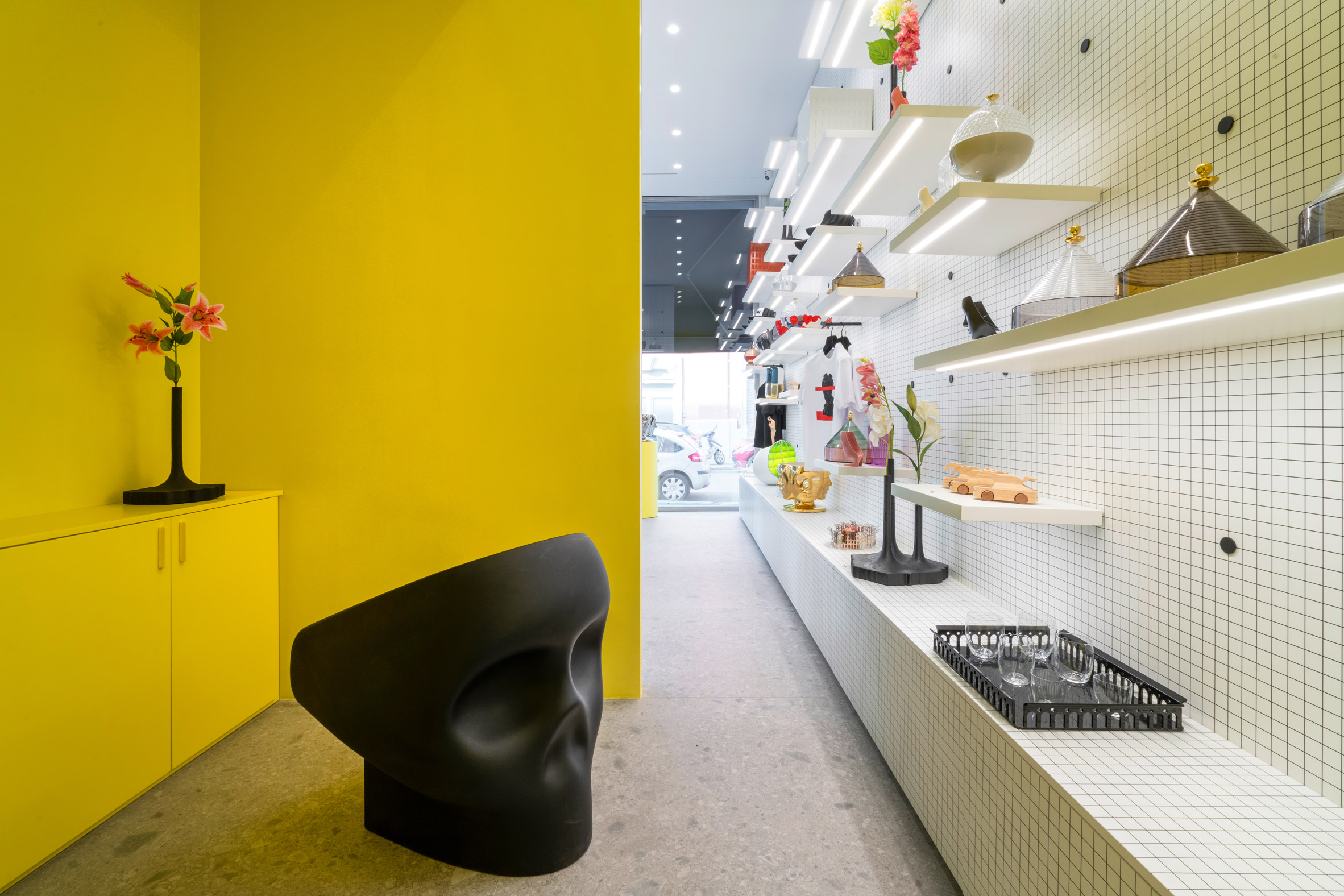 Yellow and white interior of gallery and retail space of IoNoi Gallery