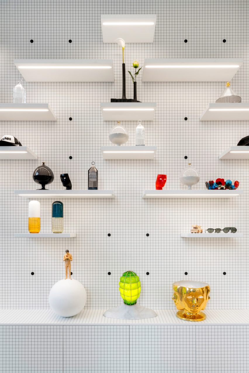 Walls with shelves on a black-and-white grid in Fabio Novembre concept store
