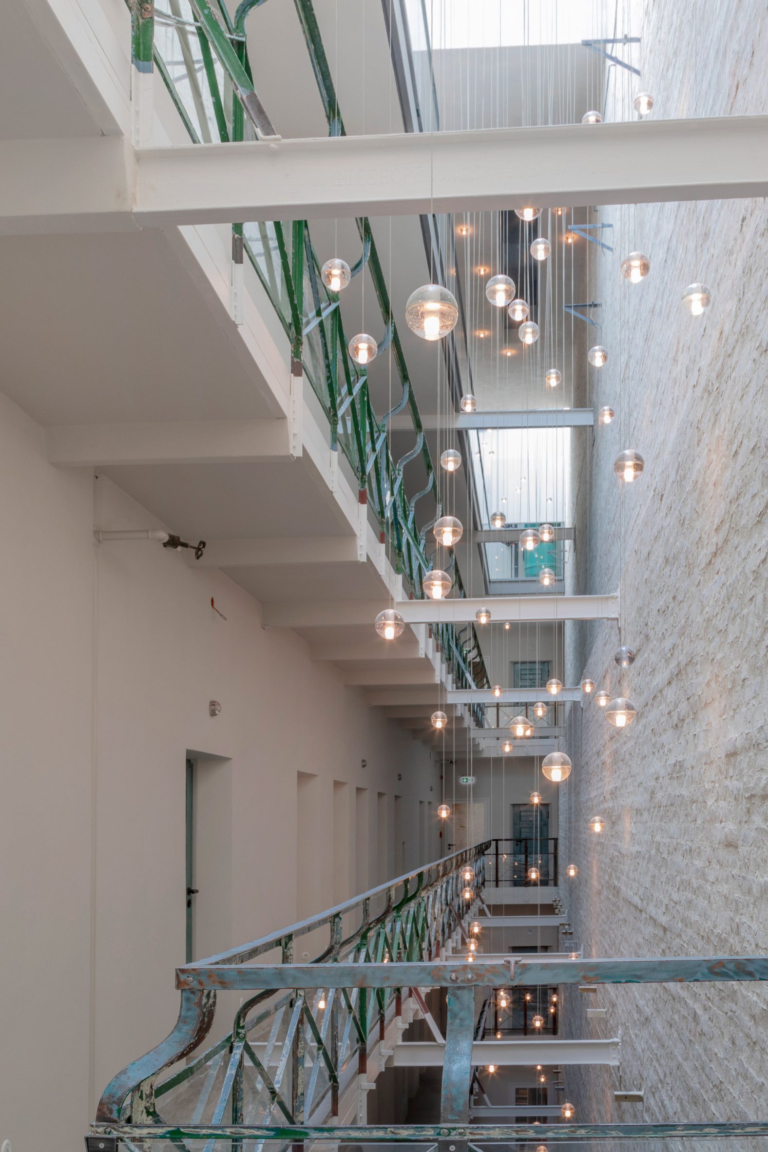 Corridors across different levels of Berlin hotel Wilmina with hanging lights