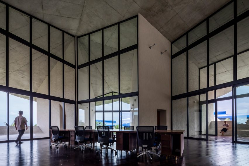 Concrete office inside with floor-to-ceiling windows inside The Kaleidoscope
