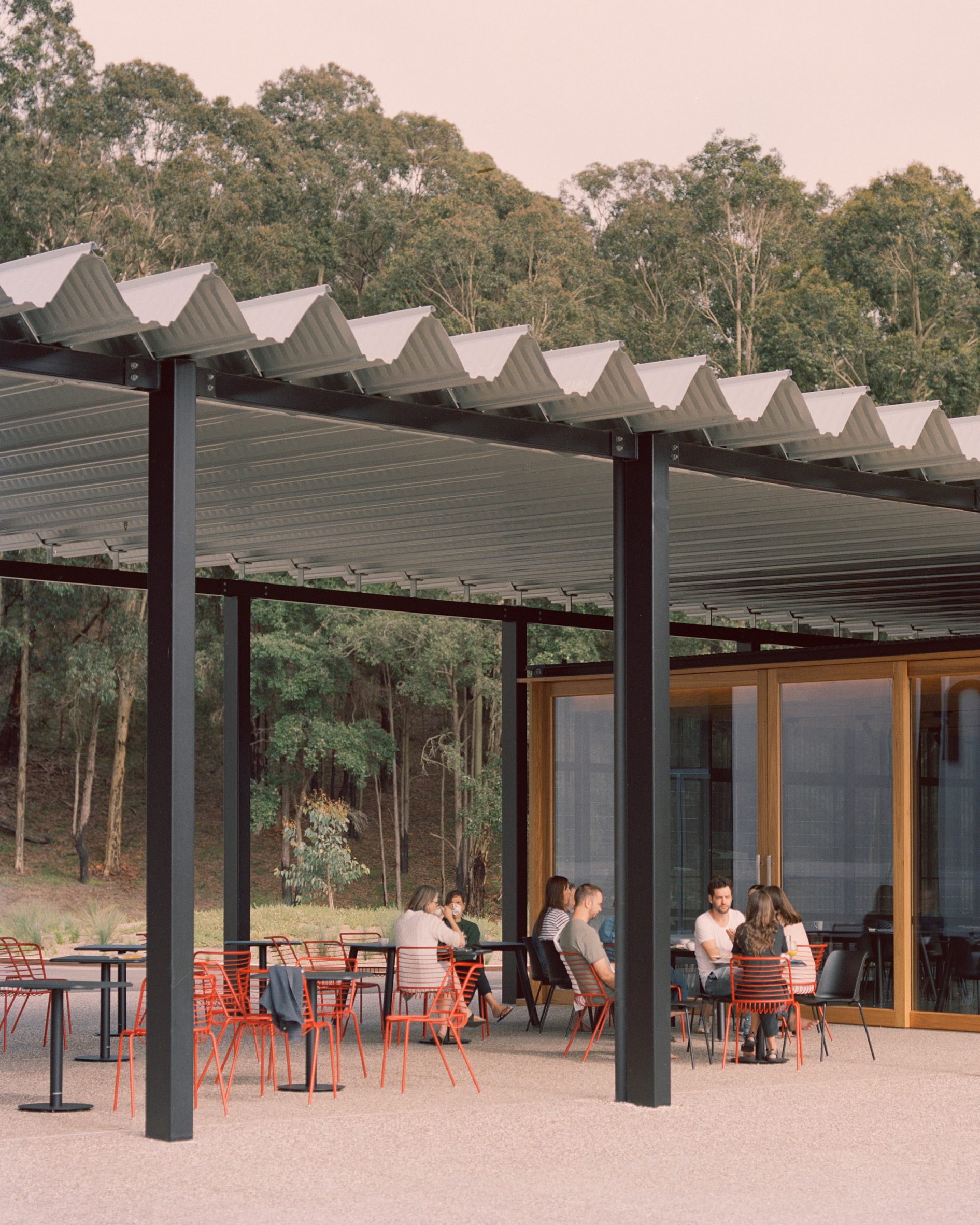 Image with people sitting under the wavy roof of the Bundanon Art Museums