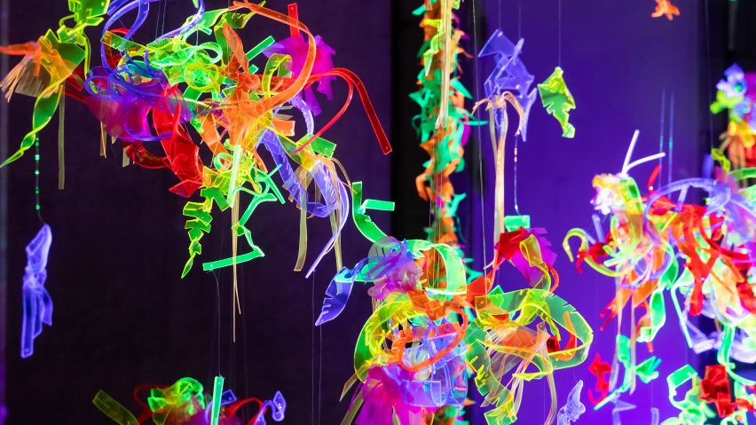 Brightly colored fluorescent shapes hanging in space illuminated with black light