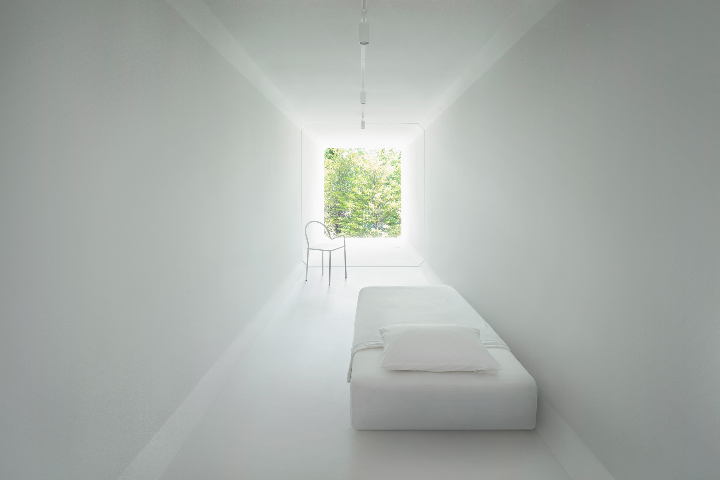 An all-white bedroom in Nendo's Culvert Guesthouse
