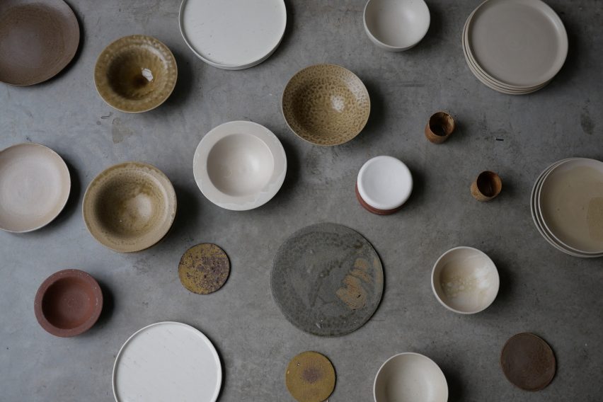 Dozens of plates and bowls with different neutral-coloured glazes by Carly Breame