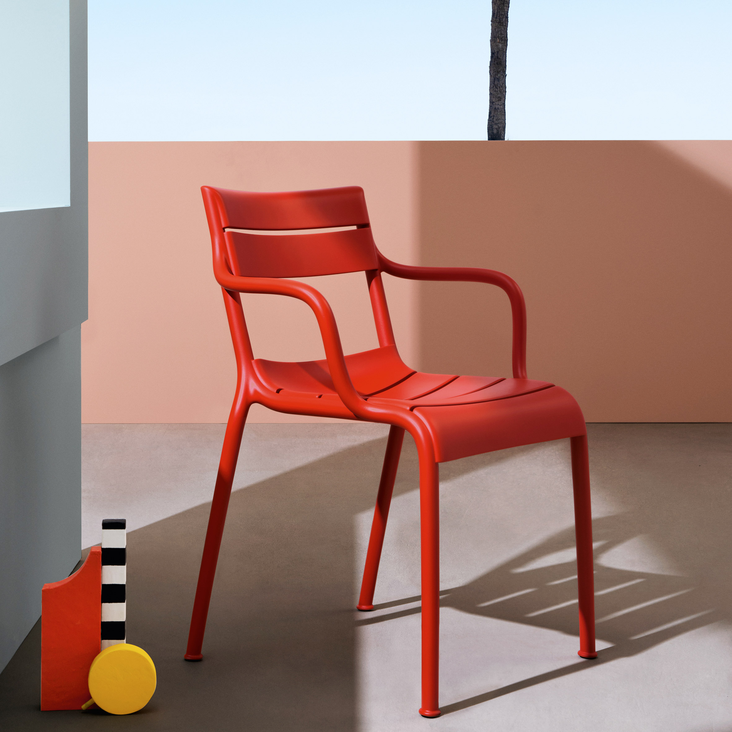 Red Souvenir outdoor chair by Eugeni Quitllet for Pedrali on a colourful terrace