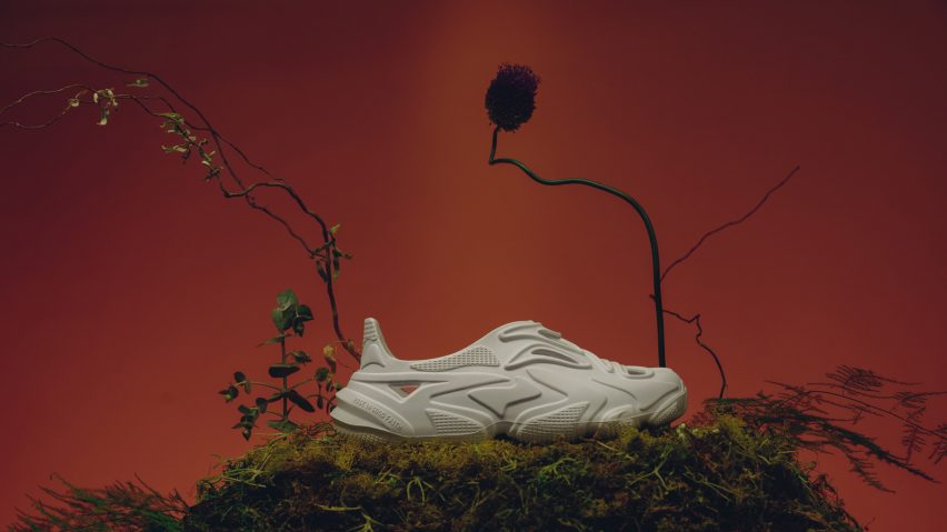 A white rubber sandal on a pile of moss
