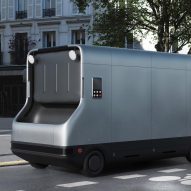 A silver autonomous and electric refuse-management truck on a street in Paris