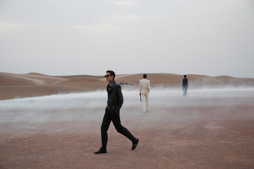 Saint Laurent models are pictured walking the desert show space by Es Devlin