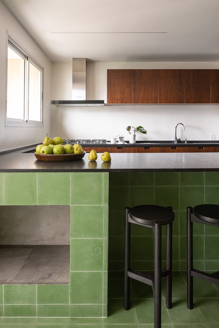 Kitchen peninsula with green tiles