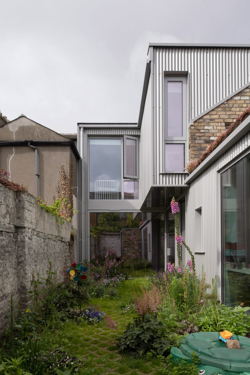 Two-storey extension clad in corrugated metal