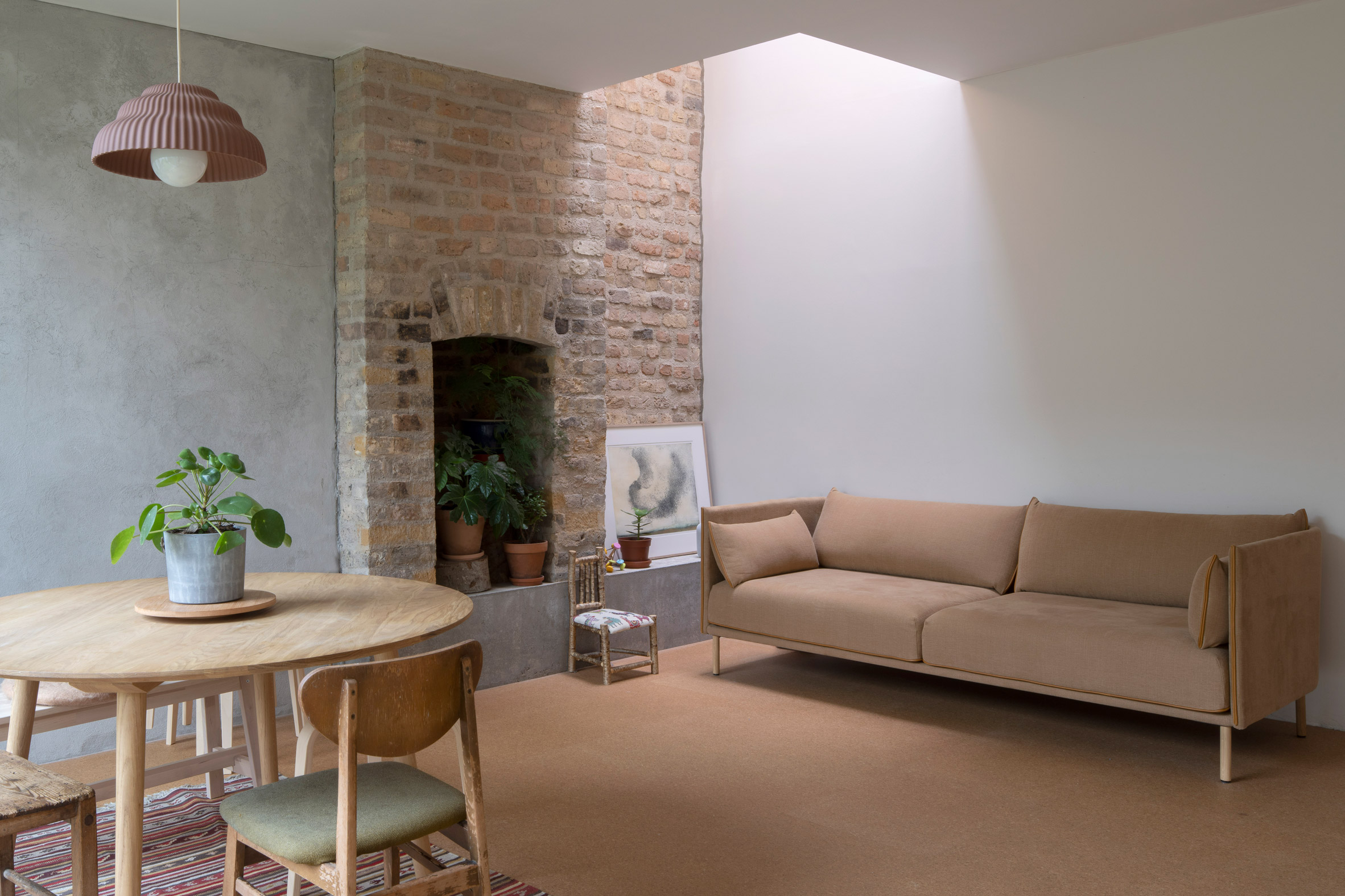 Open living area of Dublin cottage with brick wall