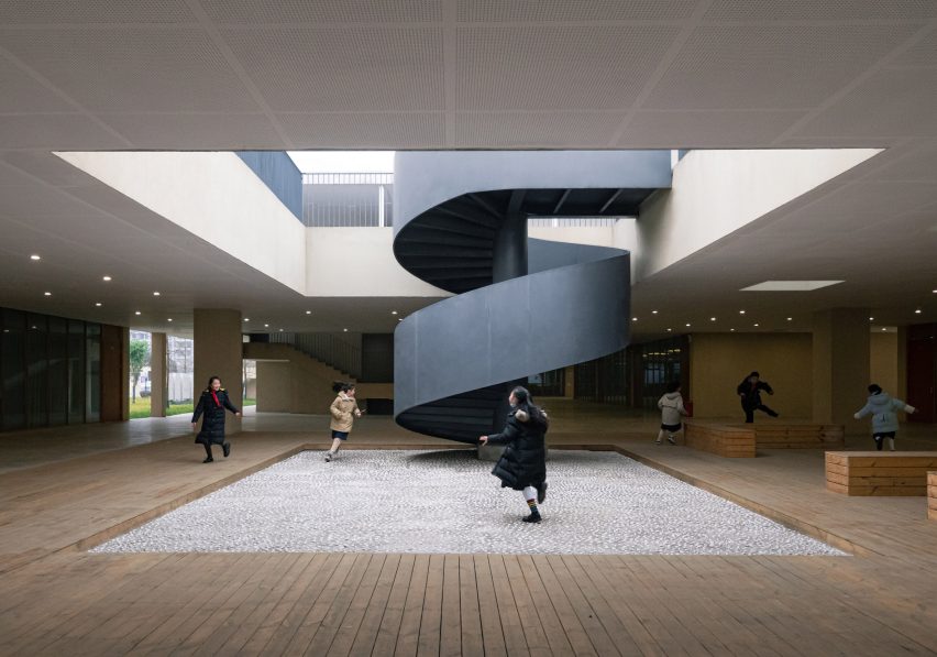 Trace Architecture Office's Dayang school with a black spiral staircase