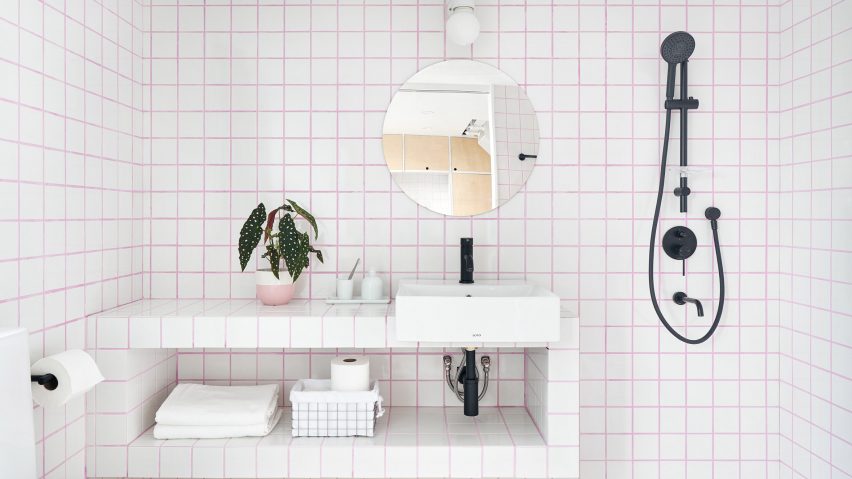 Bathroom with white tiles and pink grout