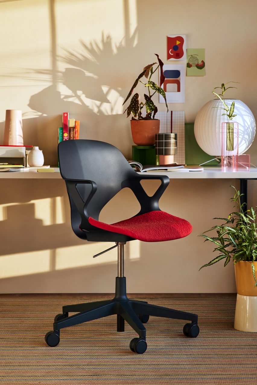 Black Zeph Chair with red upholstered seat at a home desk