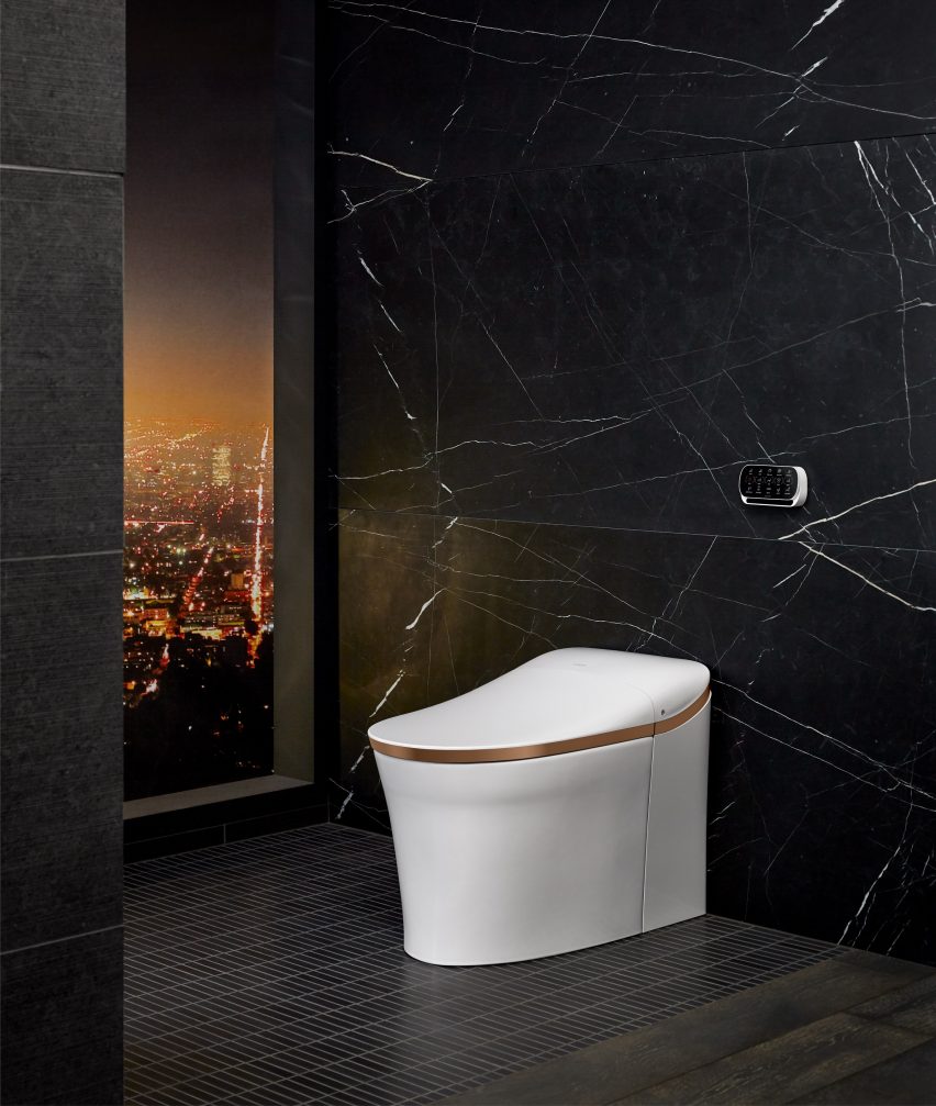A photograph of Kohler's white toilet lit up at night