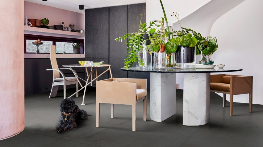 A photograph of Marazzi's grey tile collection featured in a kitchen with pink walls and a dog sitting on the floor