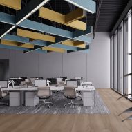 Photograph showing an office space with blue and yellow acoustic lighting grid on ceiling