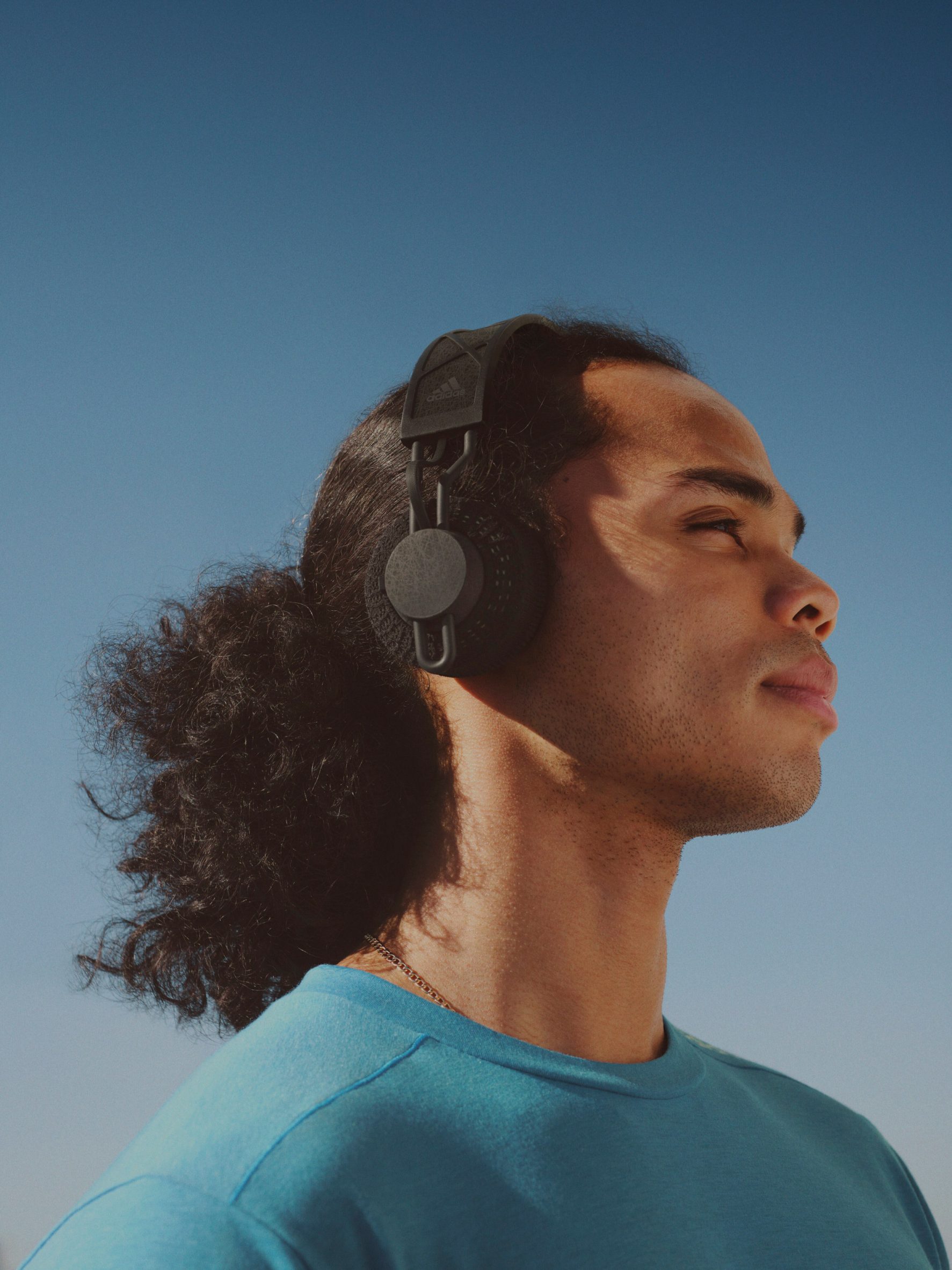 A man wearing Adidas solar powered headphones