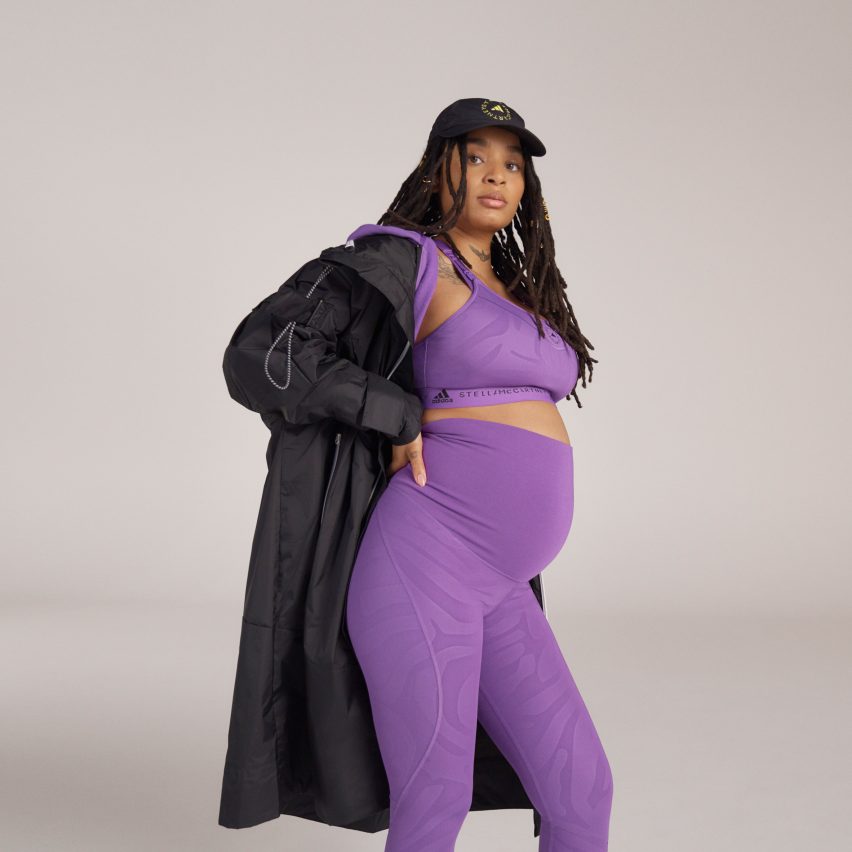 A pregnant woman wearing a purple exercise outfit