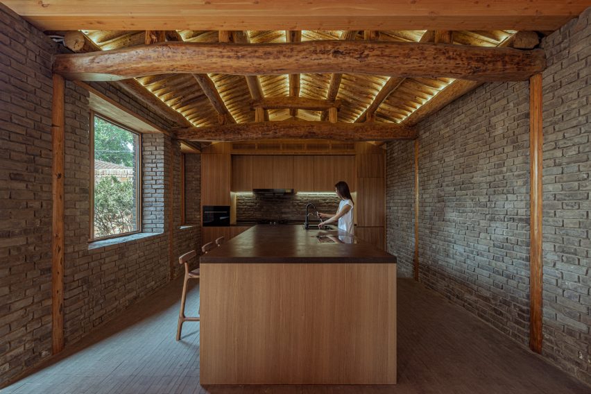 Brick-walled kitchen of Chinese home by Arch Studio