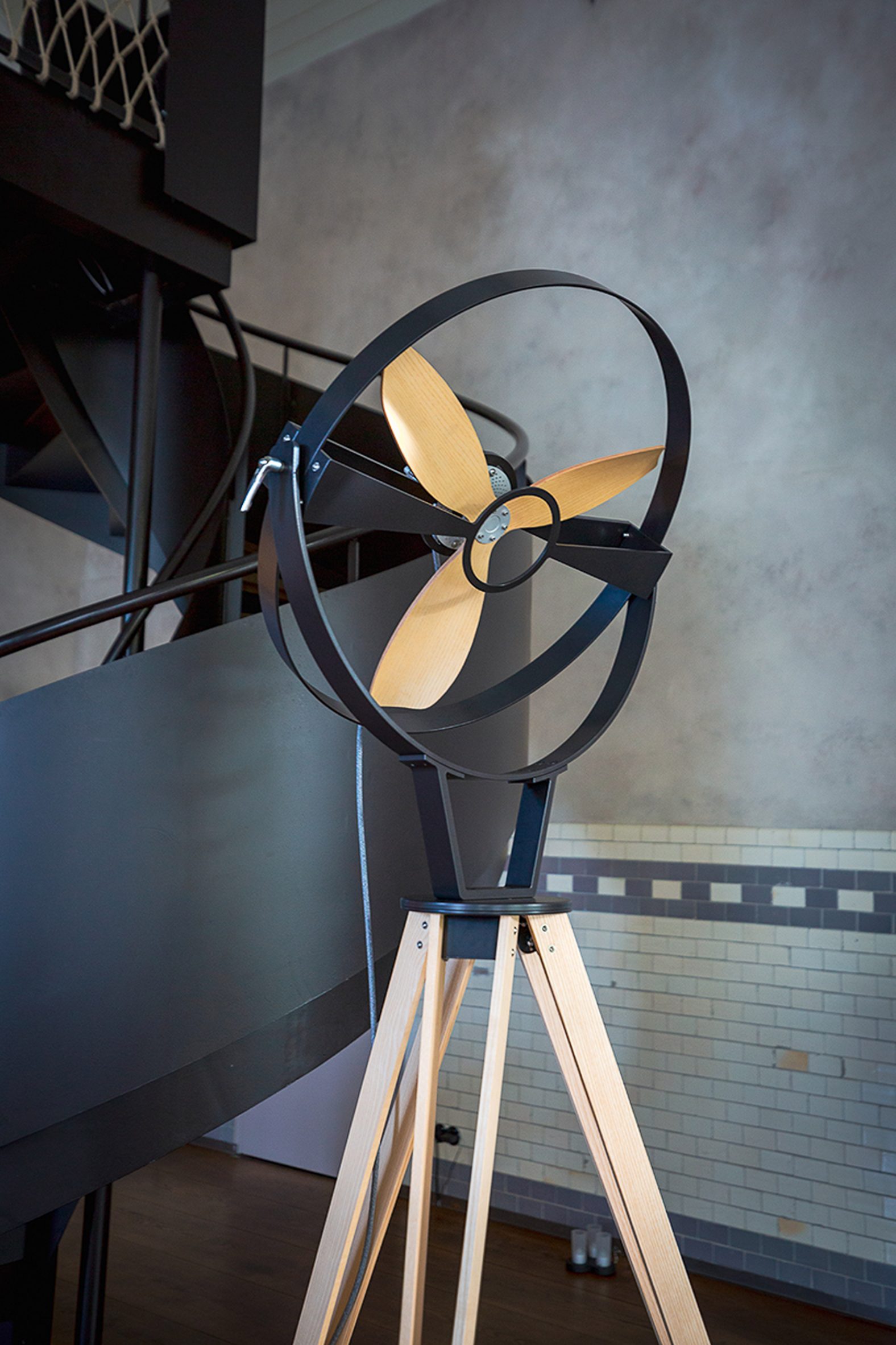 Photograph showing timber and black pedestal fan