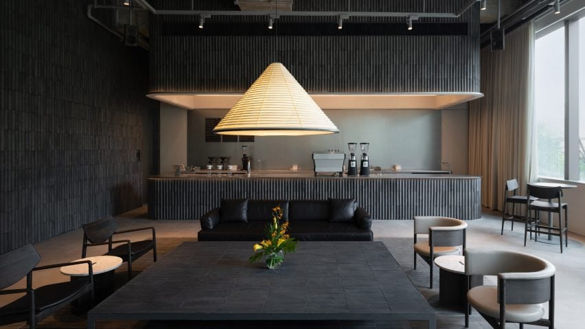 Interior Shanghai coffee shop with tiled bar and triangular paper lamp