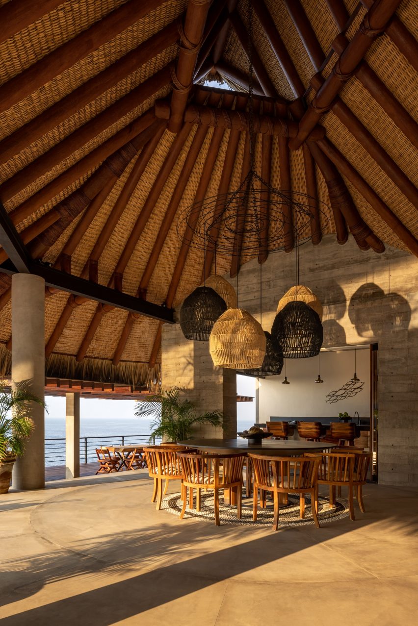 Thatched roof with sculptural lighting and dining area