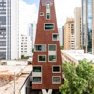 Gisele Borges Arquitetura wraps tapered apartment block in perforated "second skin"