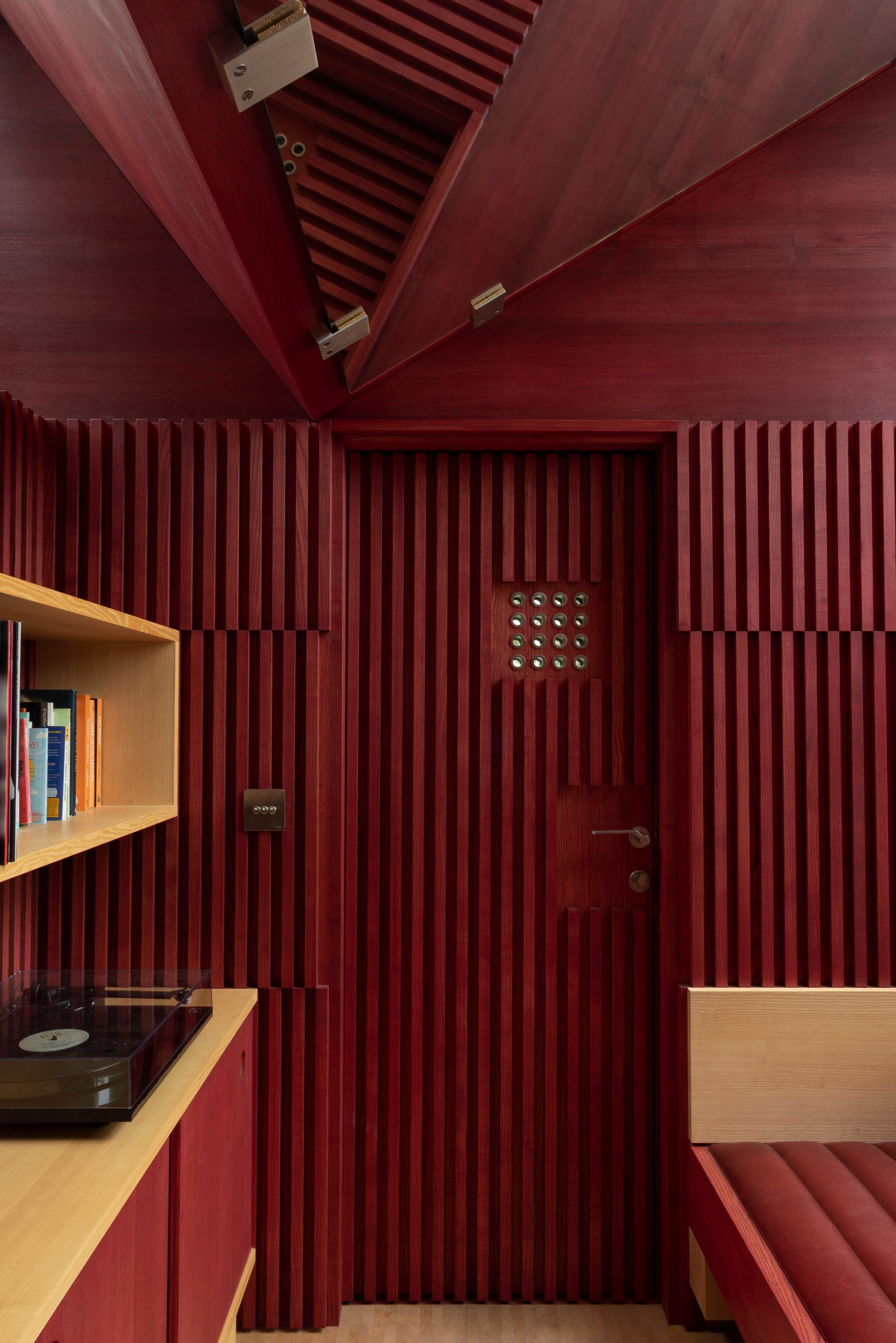Red-stained beech walls with V-shaped ceiling in a writer's hut in Ireland