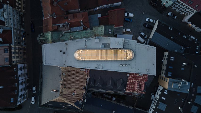 Photograph showing aerial view of building with glowing lantern rooflight