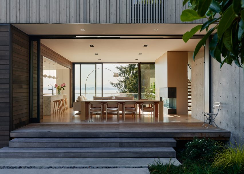 Open plan kitchen behind steps leading to terrace in Fauntleroy Residence by Heliotrope