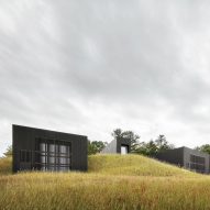 Black-clad volumes set into a hillside form Ghent House by Thomas Phifer and Partners