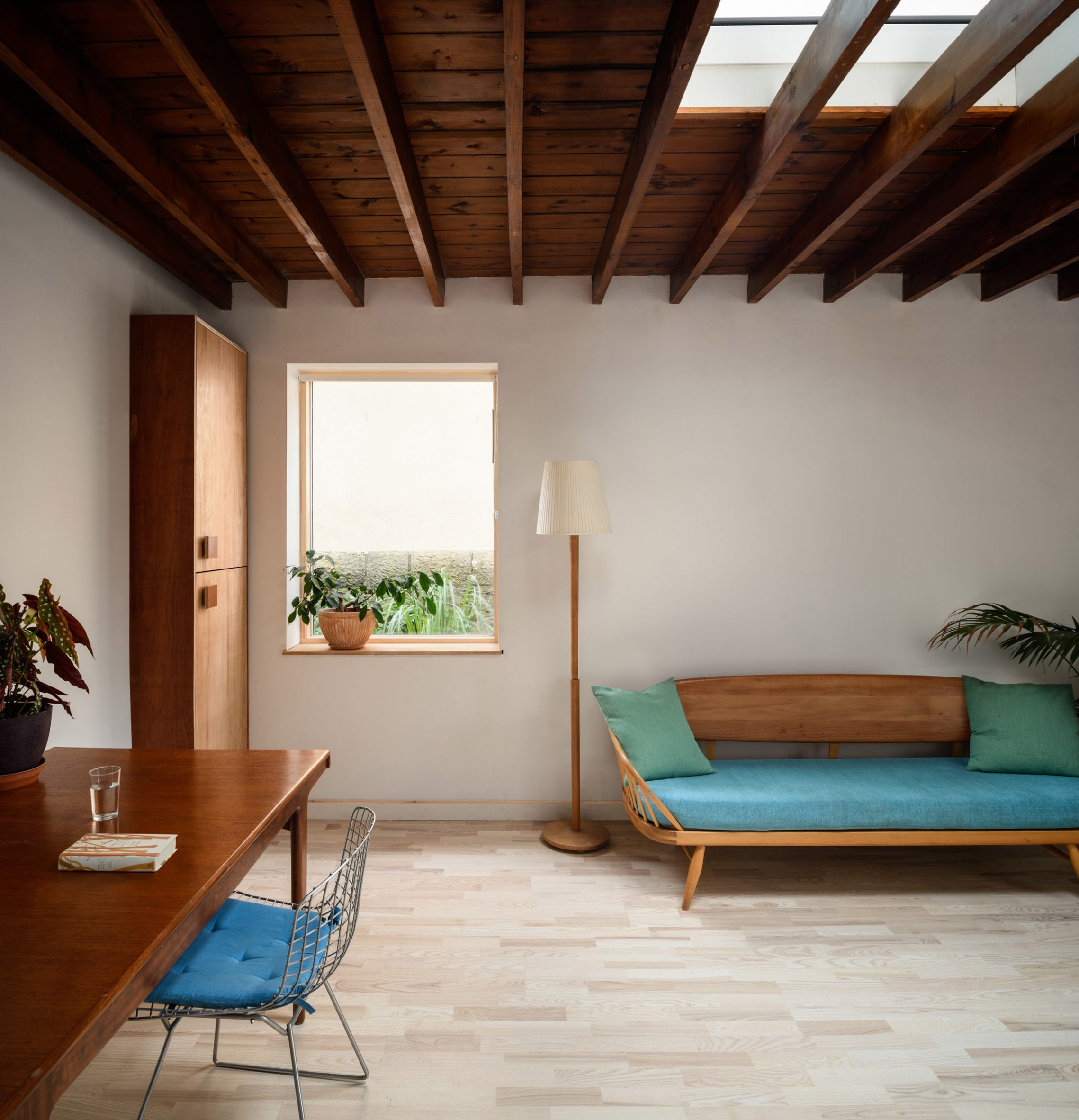 Photograph of studio interior showing desk, sofa and window