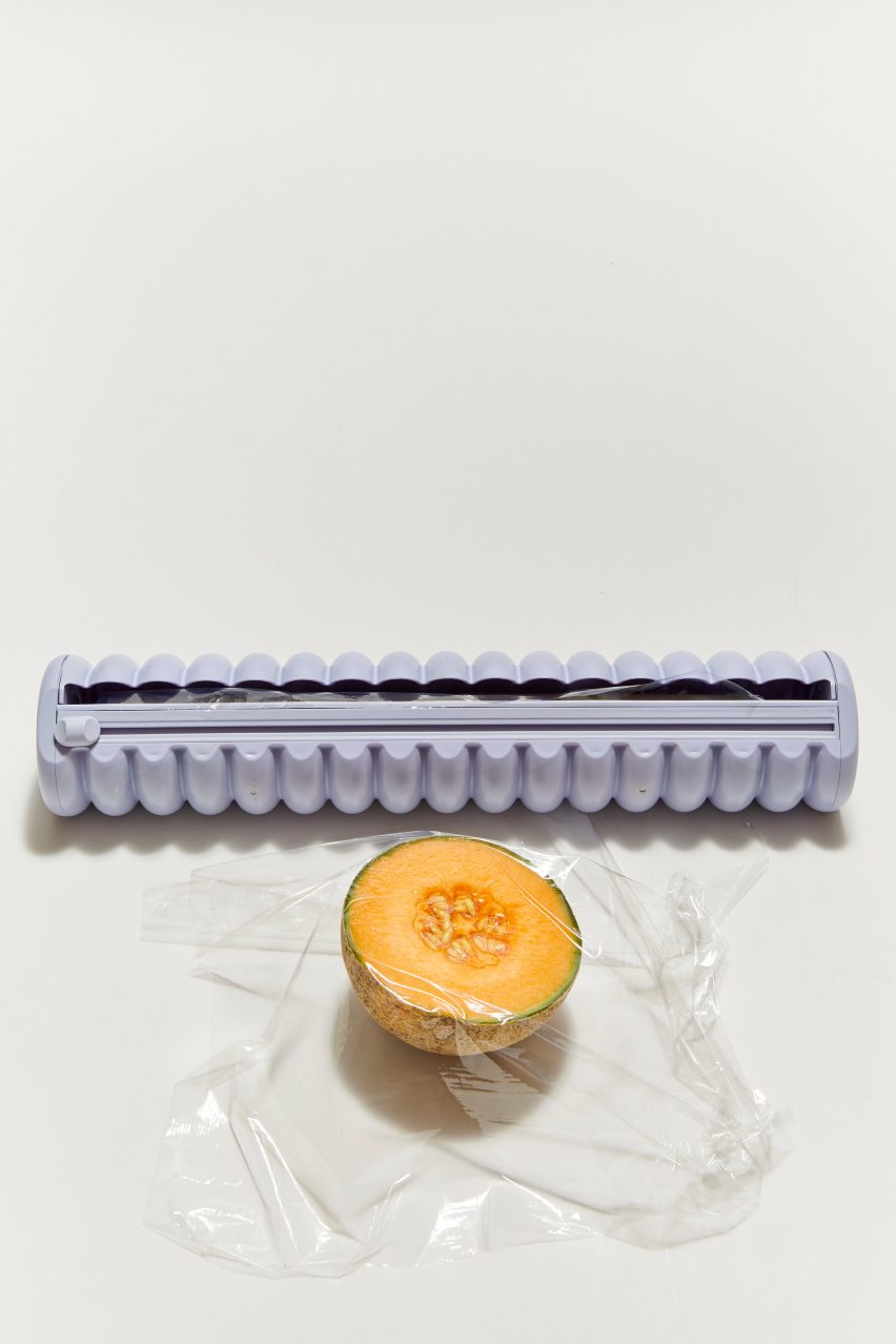 A purple cling film dispenser and a melon