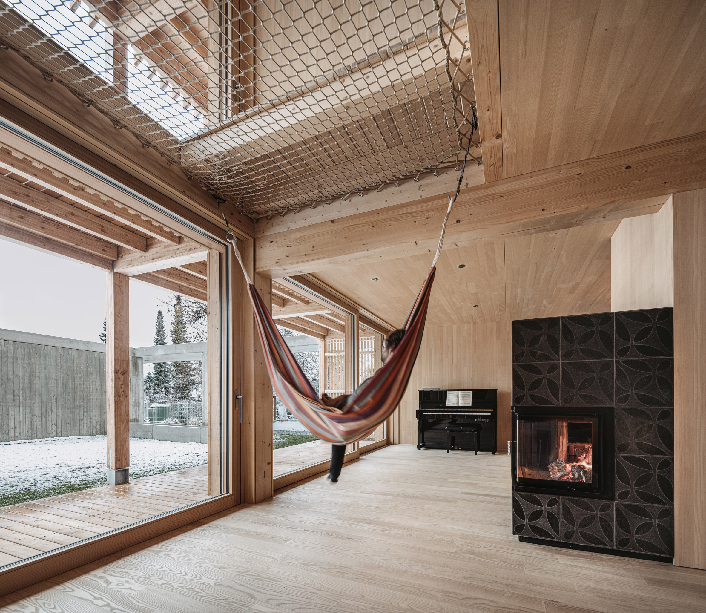 Hammock in living room hanging from netting over void in Austrian house