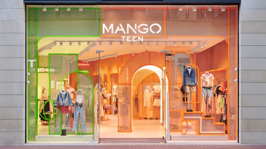 Green and orange shopfront of Mango Teen by Masquespacio with arched elements