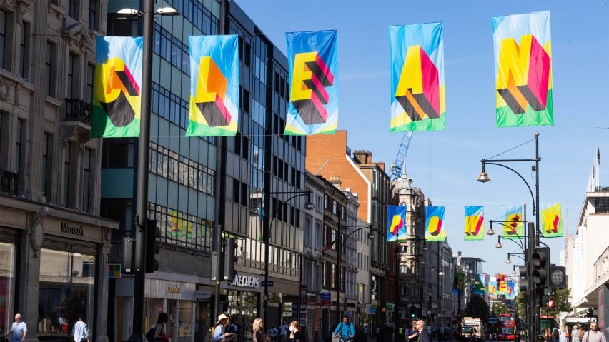 Colourful flags spelling "Clean Power" by Morag Myerscough on busy Oxford Street