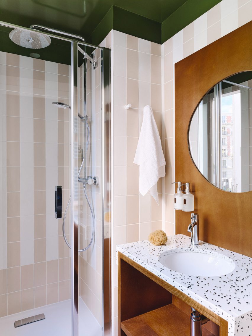 Bathroom of Hotel Rosalie by Marion Mailaender with striped tiled walls and speckled counter