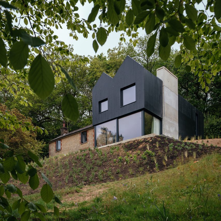 Exterior of black timber house extension by Invisible Studio