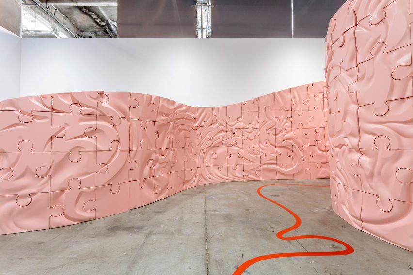 Inside the pale pink walls of the Intentionally Opaque labyrinth with a red looping line painted on the concrete floor