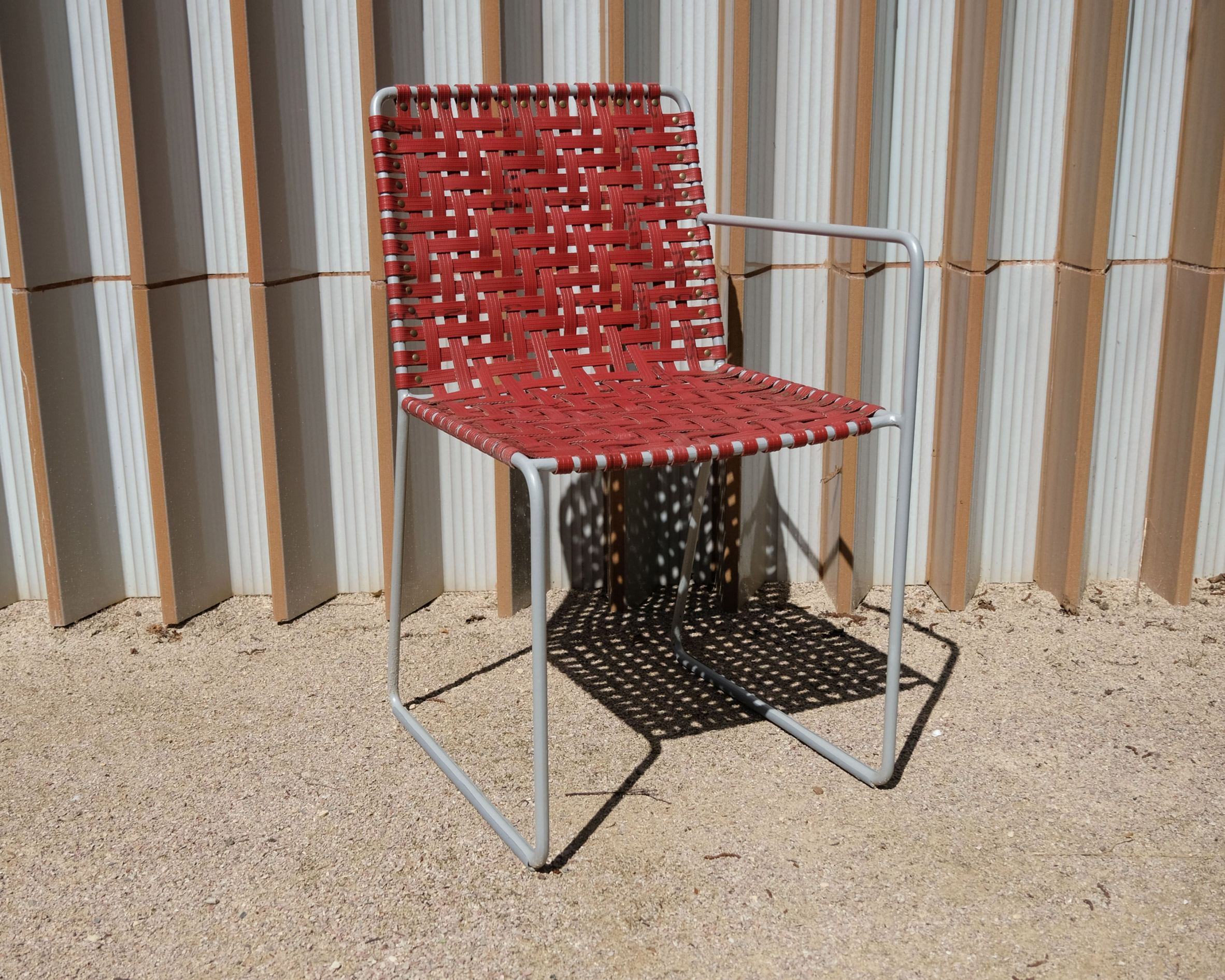 Steel-frame chair upholstered with red firehose designed by Local Works Studio for Maggie's Southampton